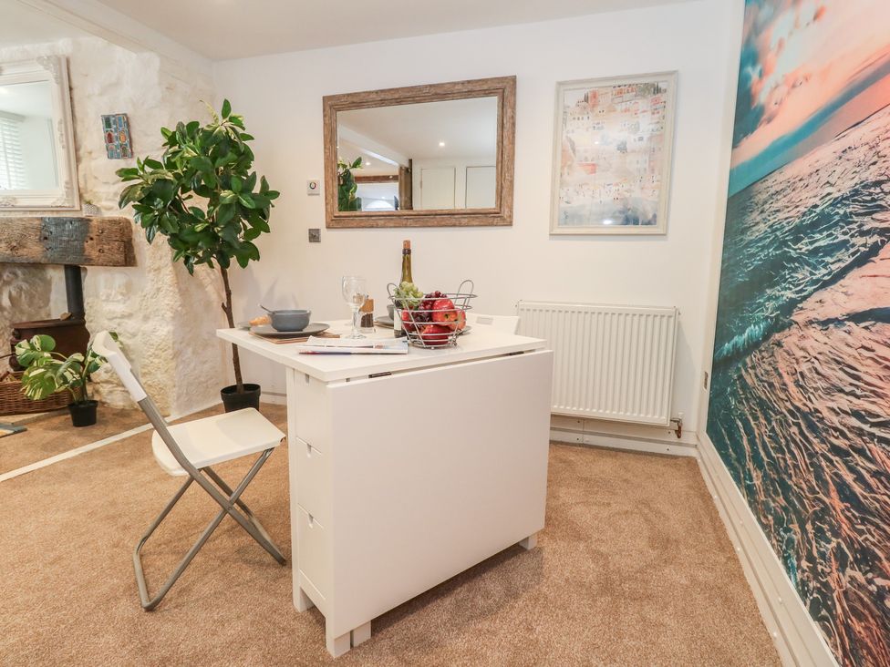 A dining room with a table and chair at Tipsy Turtle in Weymouth