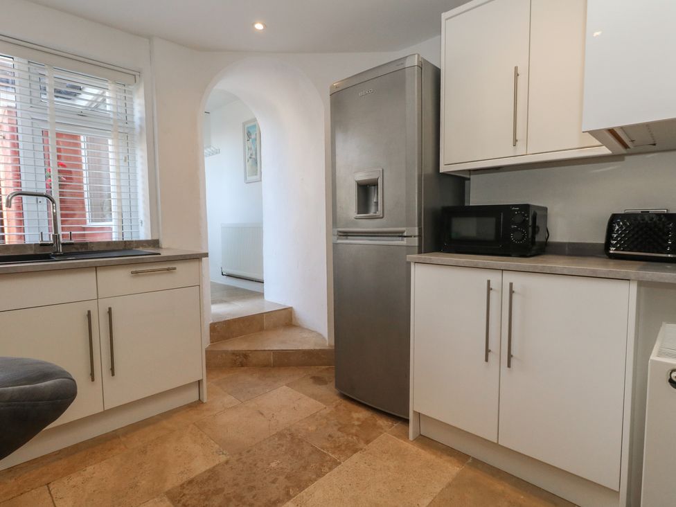A kitchen with appliances and cabinets at Tipsy Turtle in Weymouth