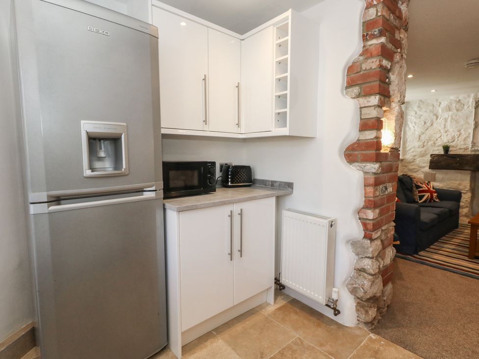 A kitchen with a refrigerator and microwave at Tipsy Turtle in Weymouth