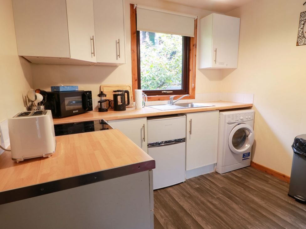 A kitchen with appliances and a sink at Thistle Lodge Dunoon