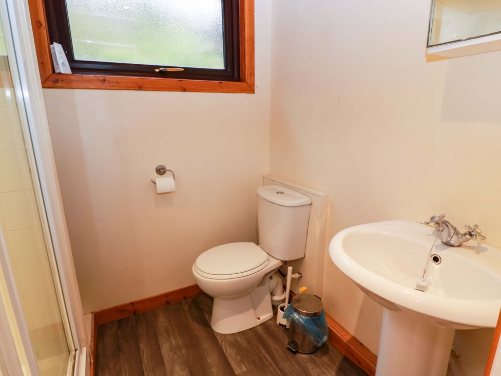 A bathroom with a toilet and sink at Thistle Lodge in Dunoon