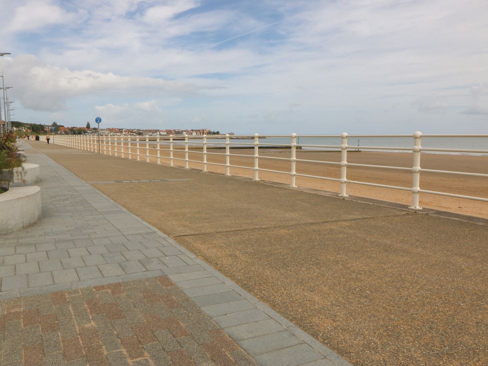 A beachside promenade with a railing at 2 Ocean View Colwyn Bay