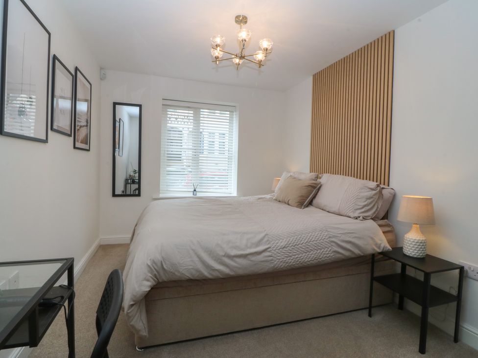 A bedroom with a bed and bedside table at 2 Ocean View in Colwyn Bay