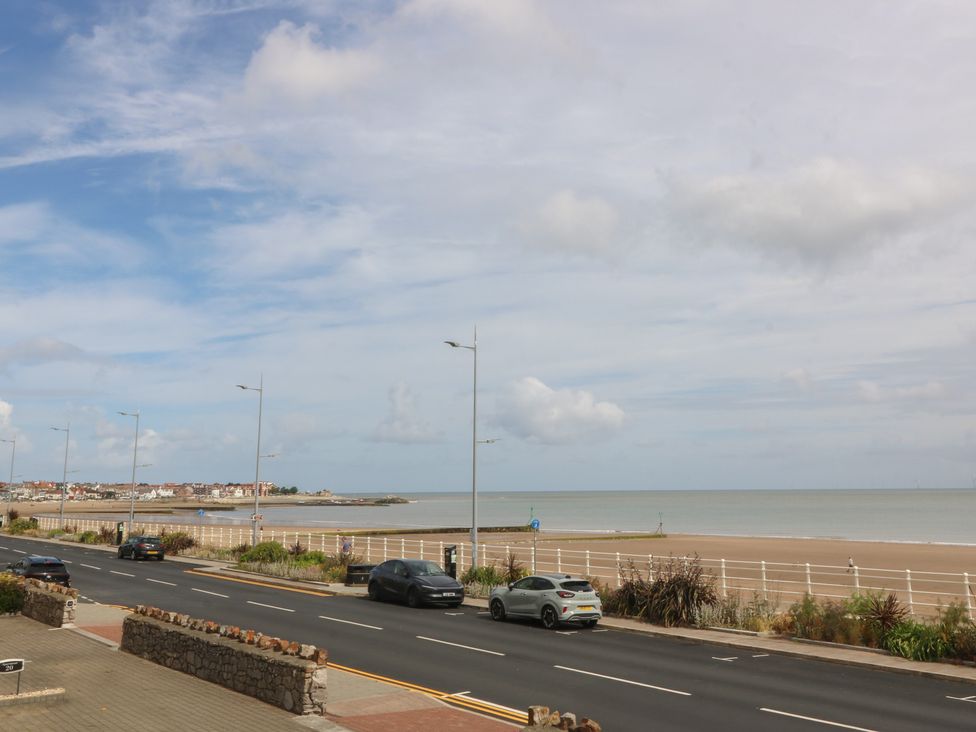 A view of the sea and road with cars at 2 Ocean View in Colwyn Bay