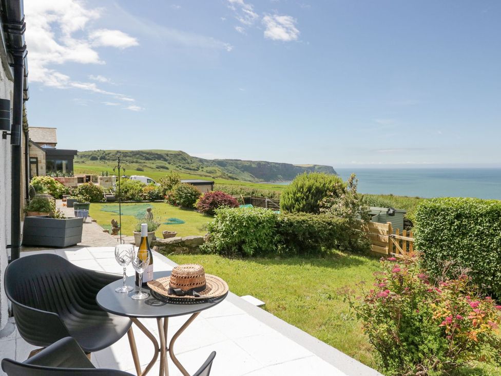A table and chairs in a garden at Victroneen Cottage Whitehaven