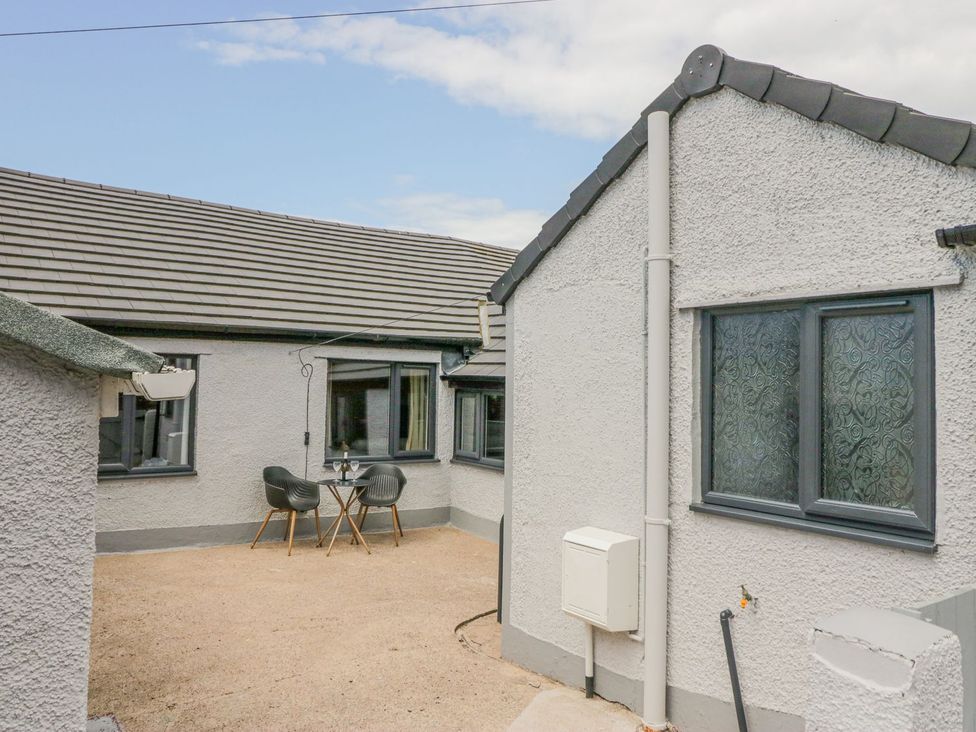 An outdoor area with a table and chairs at Victroneen Cottage Whitehaven