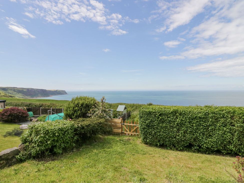 A garden view overlooking ocean and cliffs at Victroneen Cottage in Whitehaven