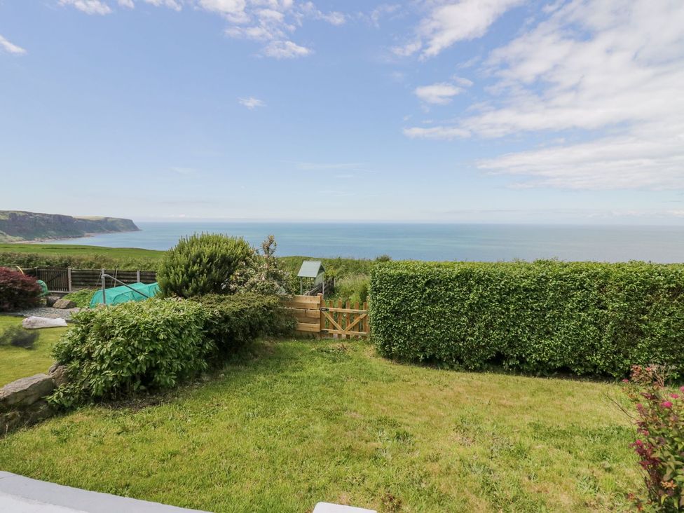 A garden with an ocean view at Victroneen Cottage in Whitehaven