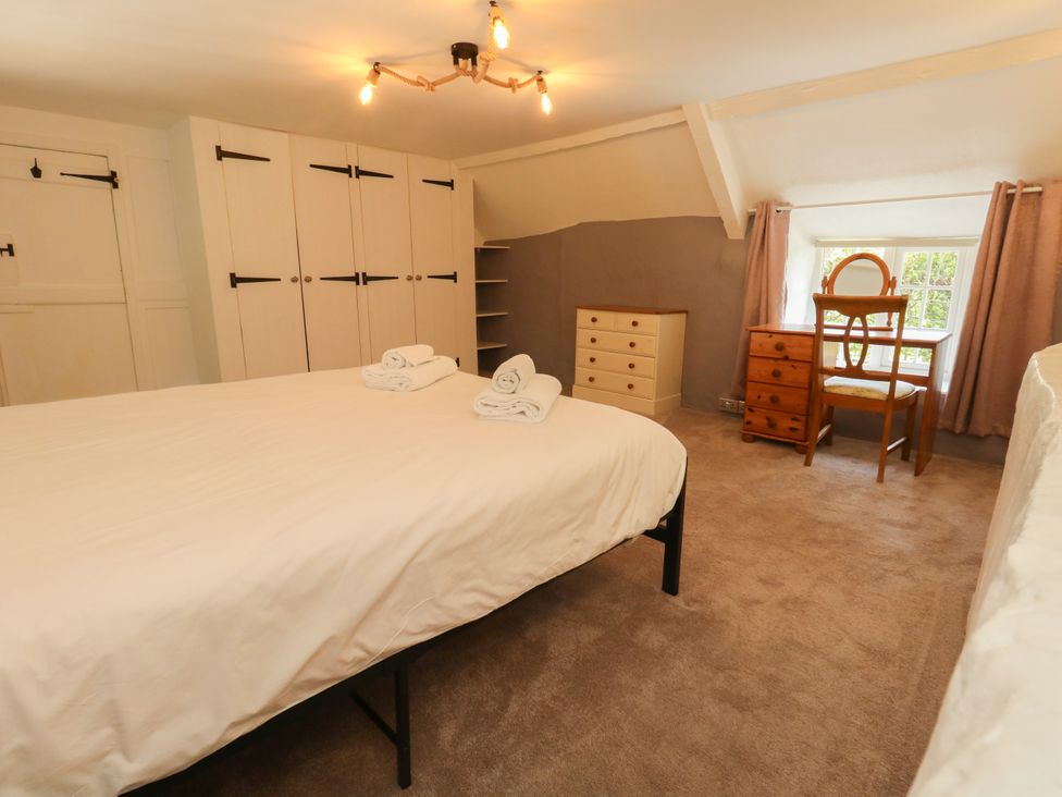 A bedroom with a bed and furniture at Rose Cottage in Osmington