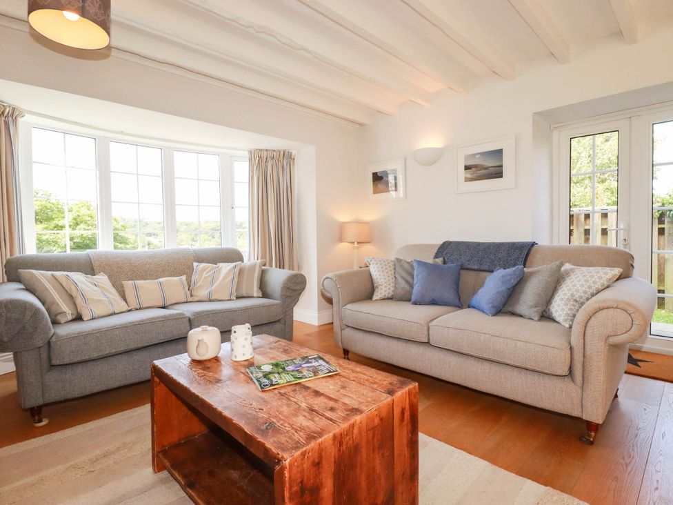 A living room with sofas and a coffee table at Bryher Cottage St Mawgan