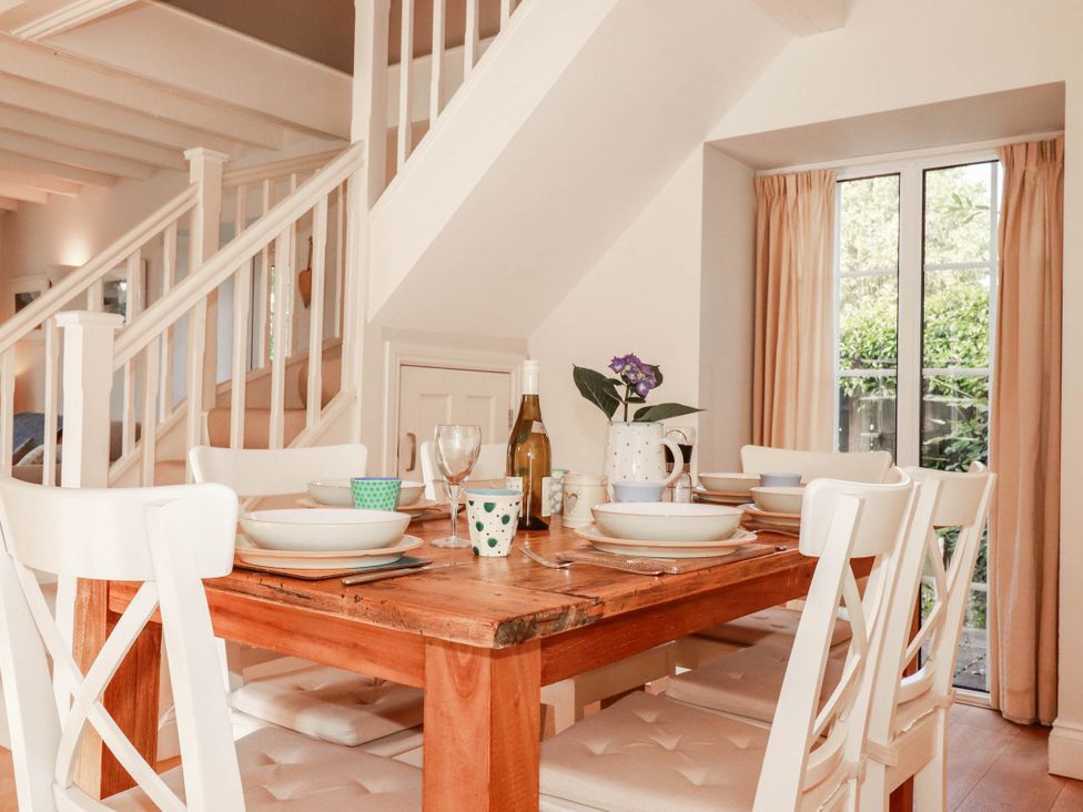 A dining room with a table and chairs at Bryher Cottage St Mawgan