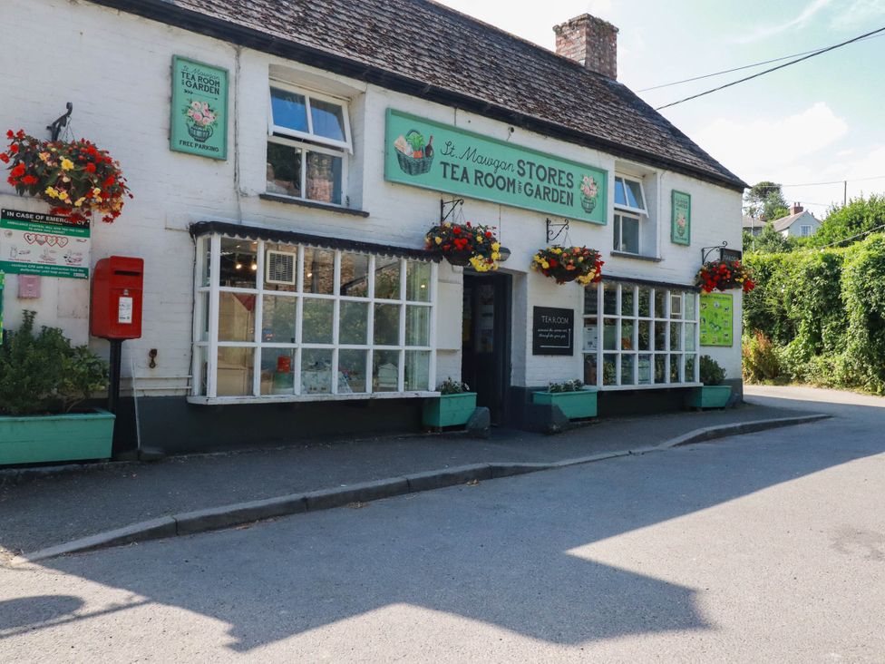 A building with signage and flowers at St Mawgan Stores Tea Room and Garden in St Mawgan