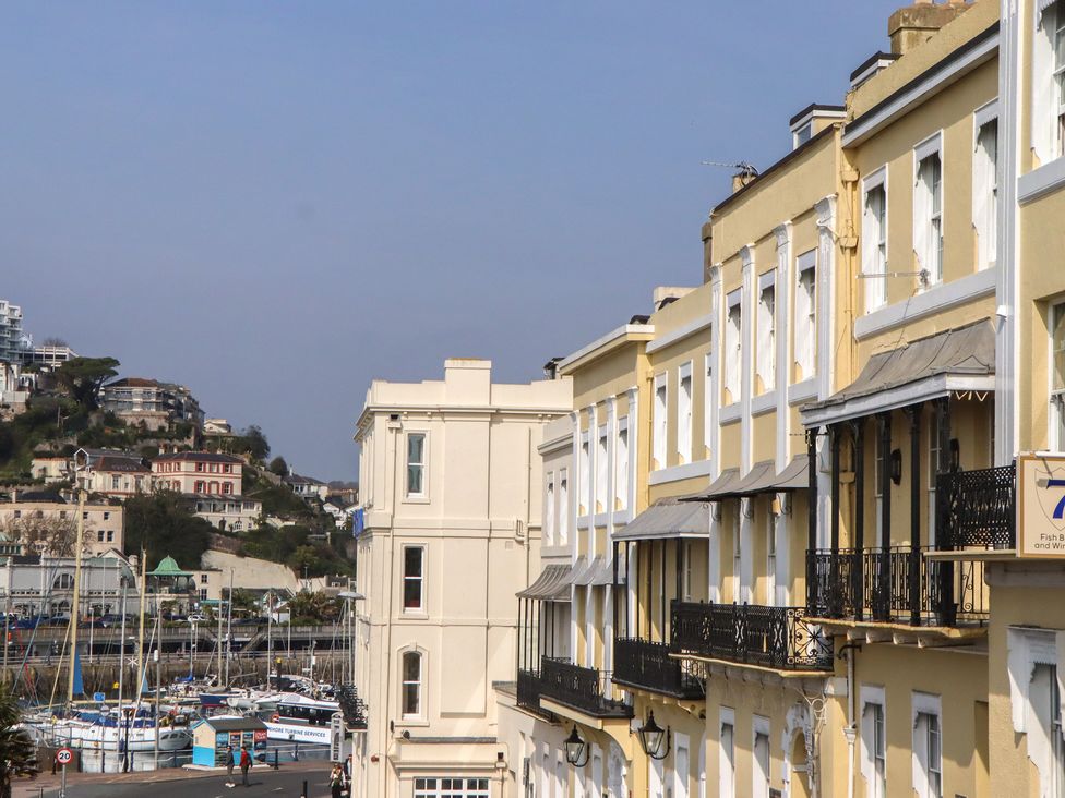A view of waterfront buildings with balconies and boats at Marina Court Apartment in Torquay