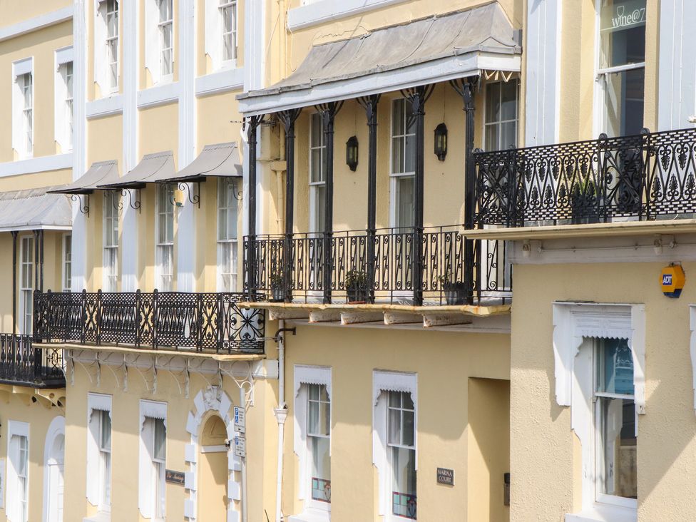 A building with a balcony and windows at Marina Court Apartment in Torquay