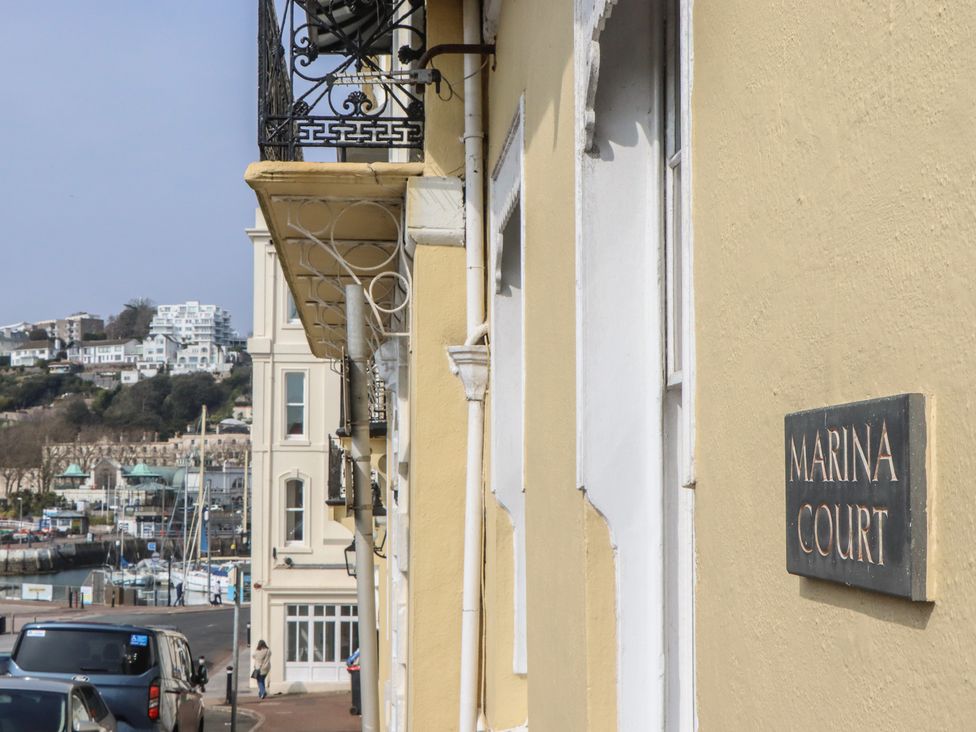 A view of Marina Court building sign along a street in Torquay