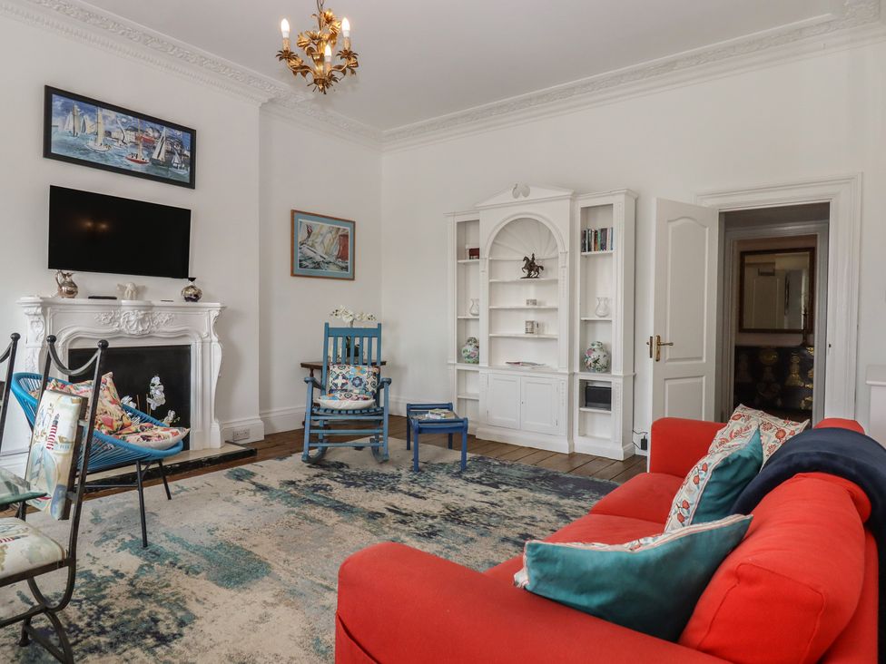 A living room with a sofa and a TV at Marina Court Apartment in Torquay