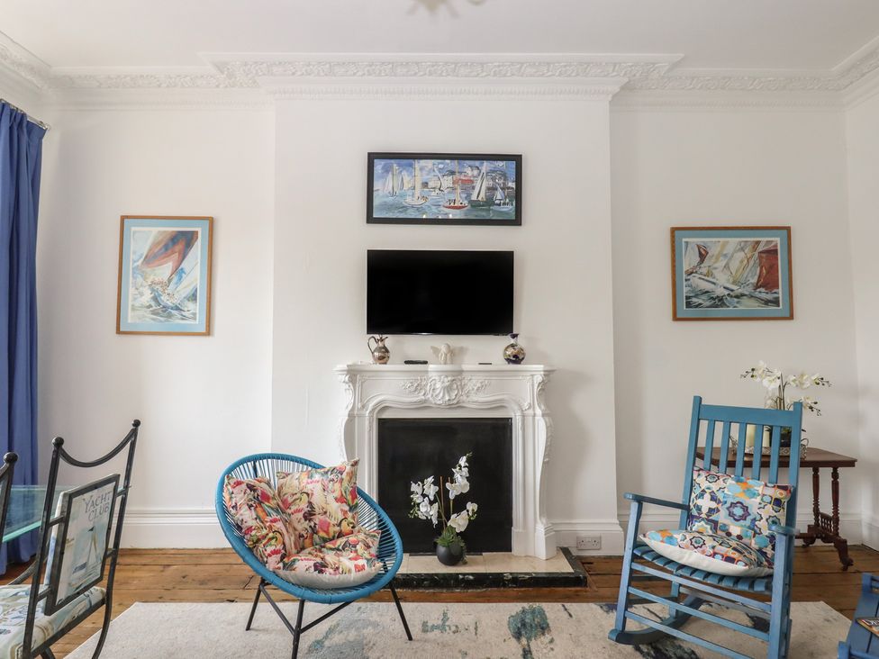 A living room with a television above a fireplace at Marina Court Apartment in Torquay