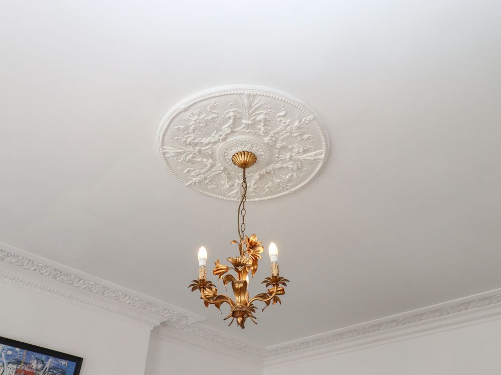 A chandelier with a ceiling rose at Marina Court Apartment in Torquay