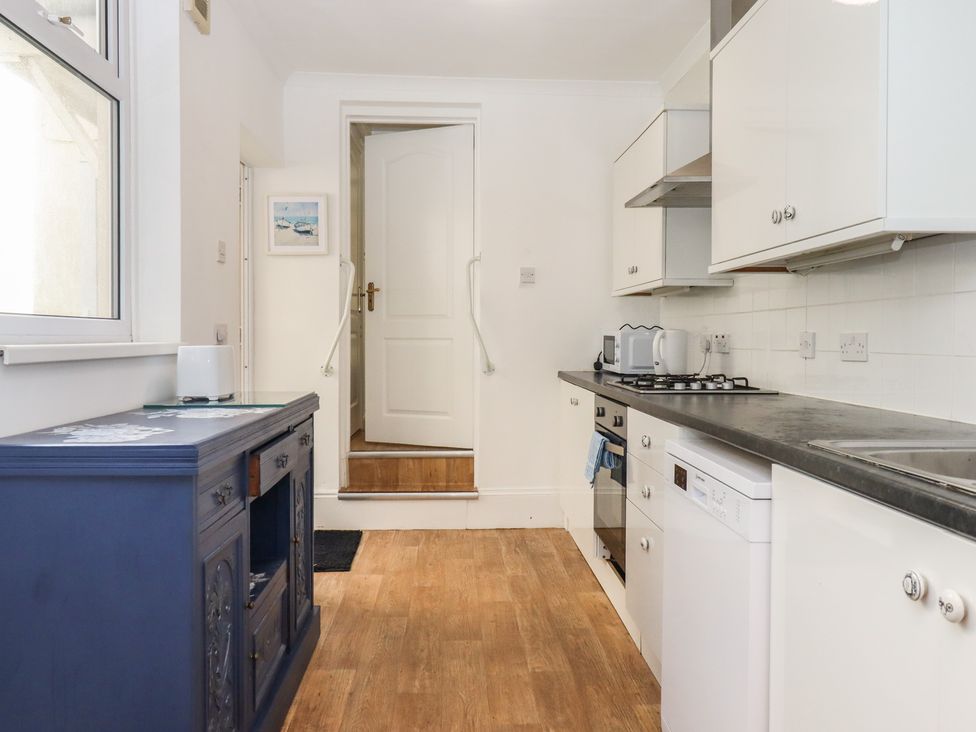 A kitchen with a stove and a dishwasher at Marina Court Apartment in Torquay