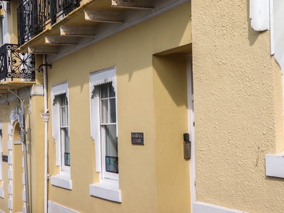An exterior view of a building with a door and windows at Marina Court Apartment in Torquay