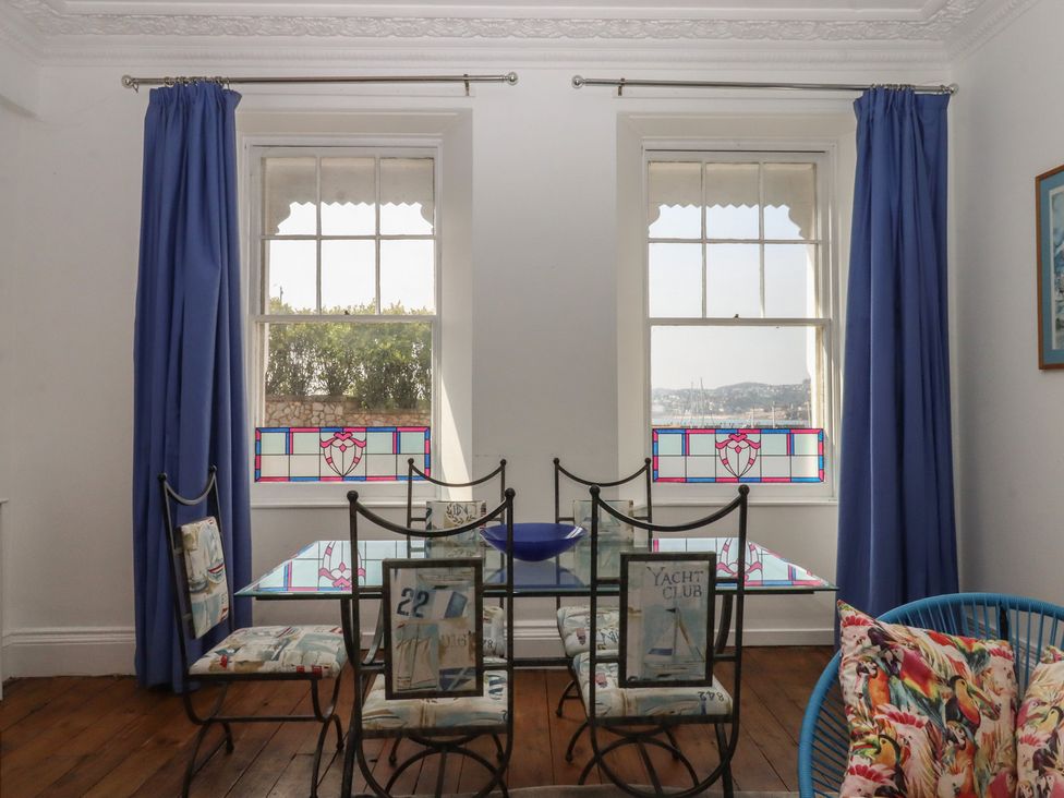 A dining room with a table and chairs at Marina Court Apartment in Torquay