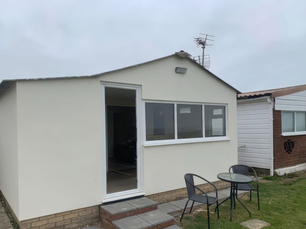 An outdoor seating area with a table and chairs at Watersmeet - 85 @ Park Avenue Holiday Village, Leysdown-On-Sea, Kent