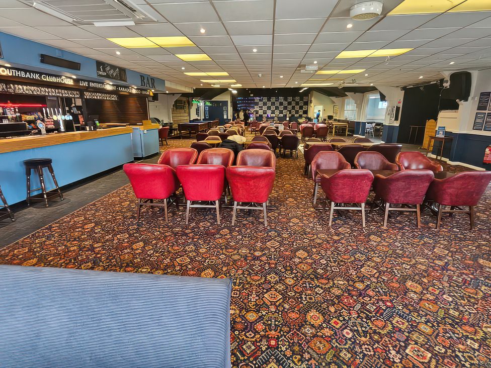 A clubhouse interior with seating and a bar at Watersmeet - 85 @ Park Avenue Holiday Village Leysdown-On-Sea, Kent