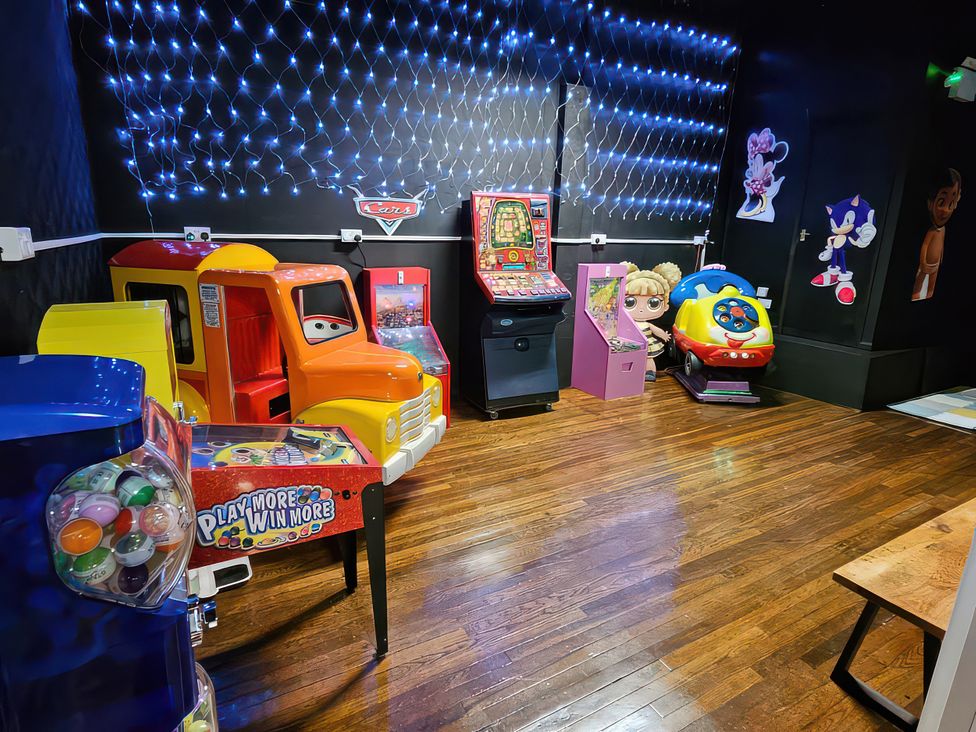 A gaming room with arcade games and toy machines at Watersmeet - 85 @ Park Avenue Holiday Village, Leysdown-On-Sea, Kent