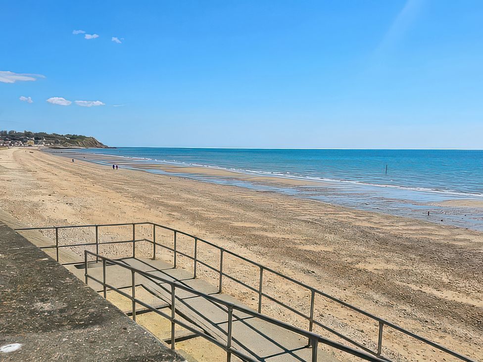 A beach view with a pathway and sea in Leysdown-On-Sea, Kent at Watersmeet - 85 @ Park Avenue Holiday Village