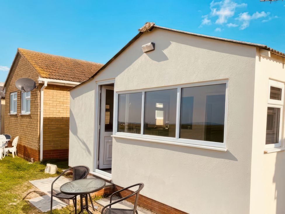 An outdoor area with a table and chairs at Watersmeet - 85 @ Park Avenue Holiday Village Leysdown-On-Sea, Kent