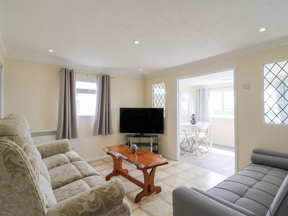 A living room with a sofa and television at Watersmeet - 85 @ Park Avenue Holiday Village, Leysdown-On-Sea, Kent