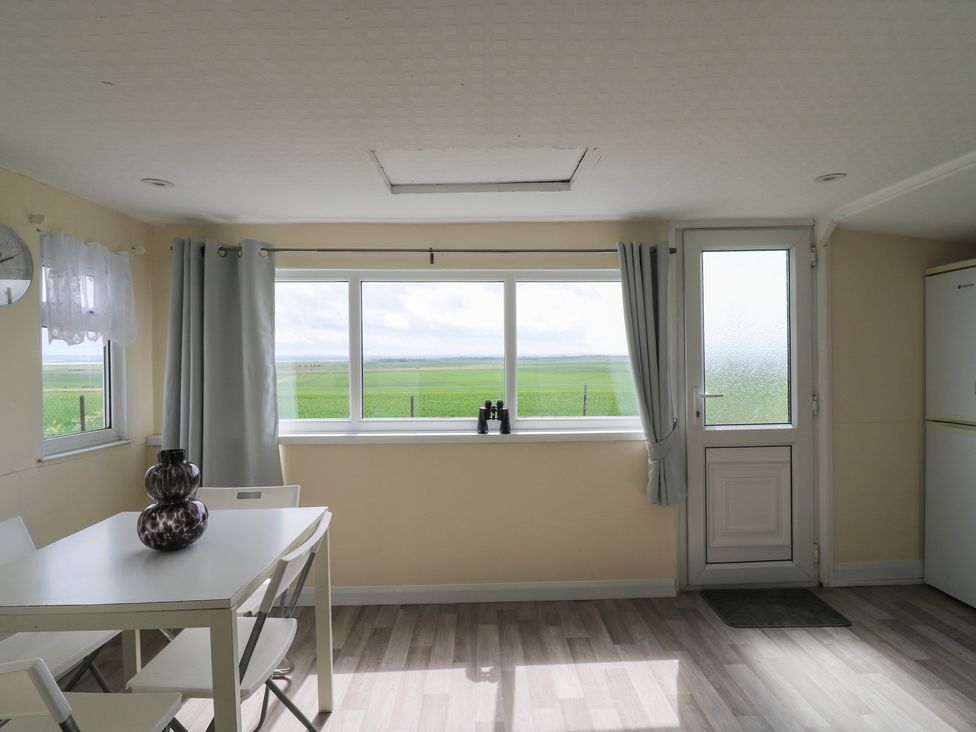 A dining room with a table and chairs at Watersmeet - 85 @ Park Avenue Holiday Village Leysdown-On-Sea, Kent