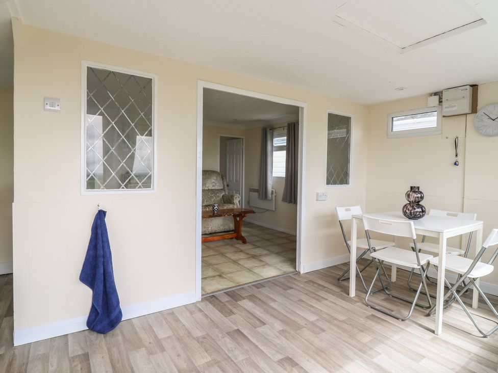 A dining room with a table and chairs at Watersmeet - 85 @ Park Avenue Holiday Village, Leysdown-On-Sea, Kent