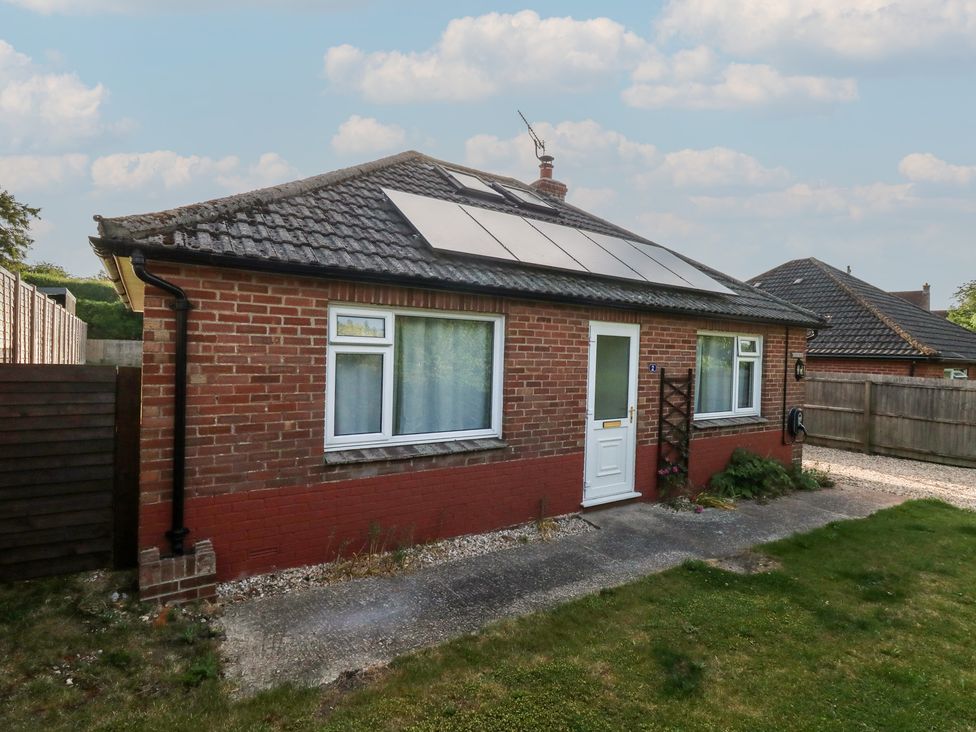 A house with solar panels and a garden at 2 North Road in Maiden Newton, Dorset