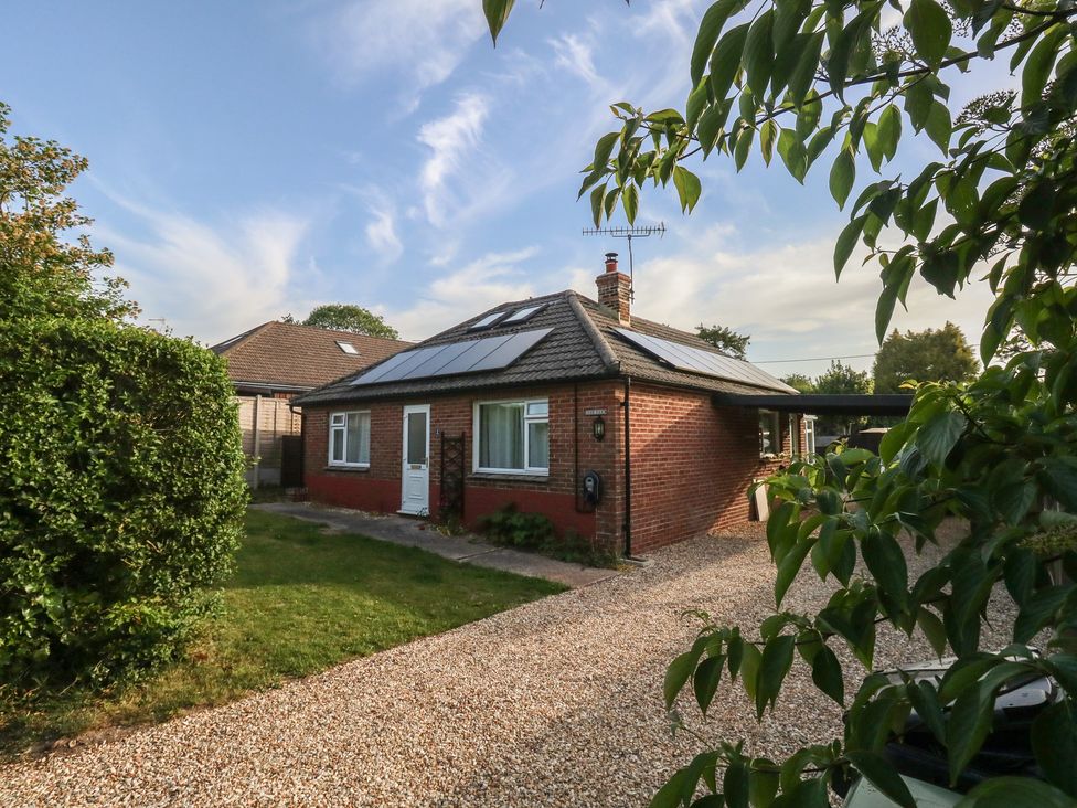 A house with solar panels and a gravel driveway at 2 North Road Maiden Newton, Dorset