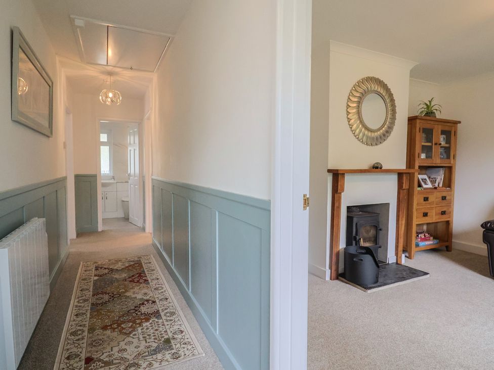A hallway with a mirror and fireplace at 2 North Road, Maiden Newton, Dorset