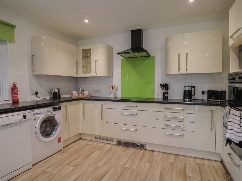 A kitchen with appliances and storage cabinets at 2 North Road Maiden Newton, Dorset
