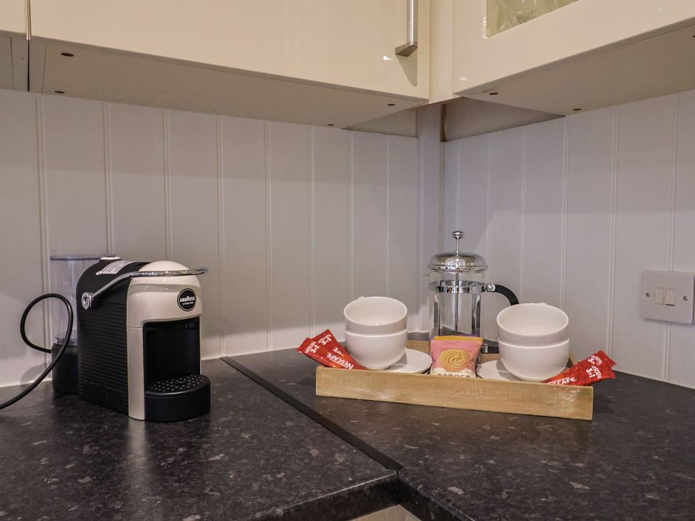 A kitchen with a coffee machine, cups, and a tray at 2 North Road, Maiden Newton, Dorset
