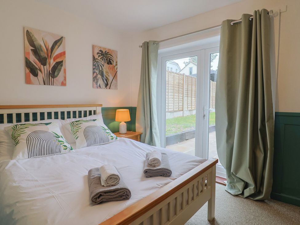 A bedroom with a bed and window at 2 North Road Maiden Newton, Dorset