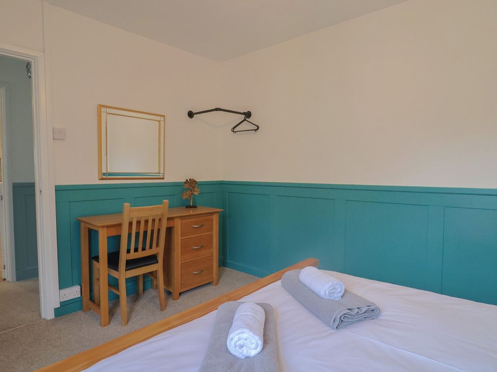 A bedroom with a bed and desk at 2 North Road, Maiden Newton, Dorset