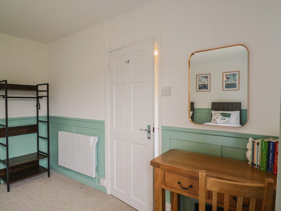 A bedroom with a desk and shelves at 2 North Road, Maiden Newton, Dorset