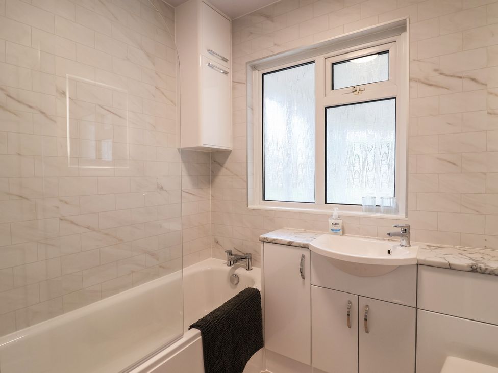 A bathroom with a bathtub and sink at 2 North Road, Maiden Newton, Dorset