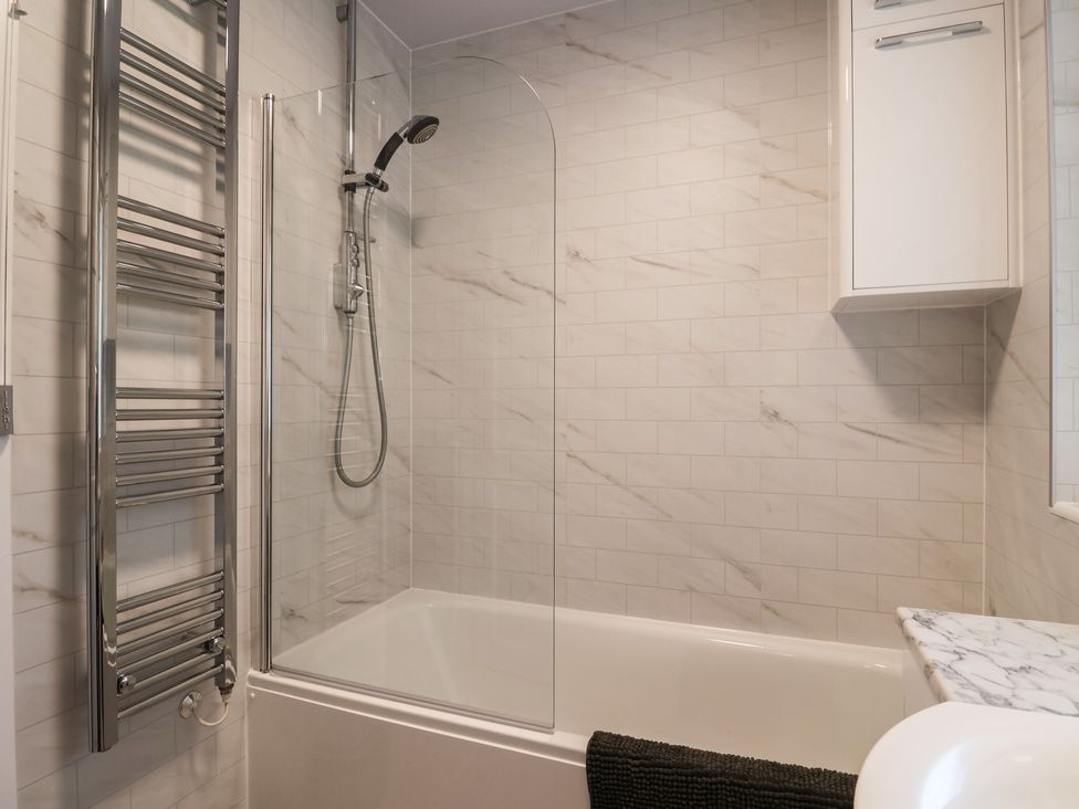 A bathroom with a bathtub and shower at 2 North Road in Maiden Newton, Dorset