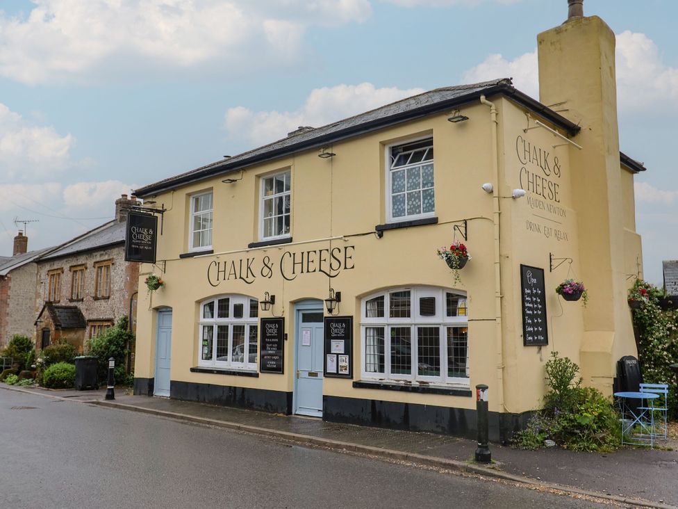 A pub exterior with signage and flower planters at 2 North Road Maiden Newton