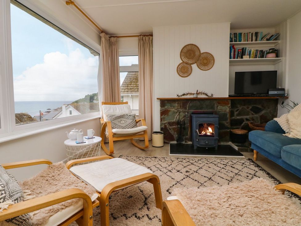 A living room with a fireplace and sofa at Wootton Gray in Penzance
