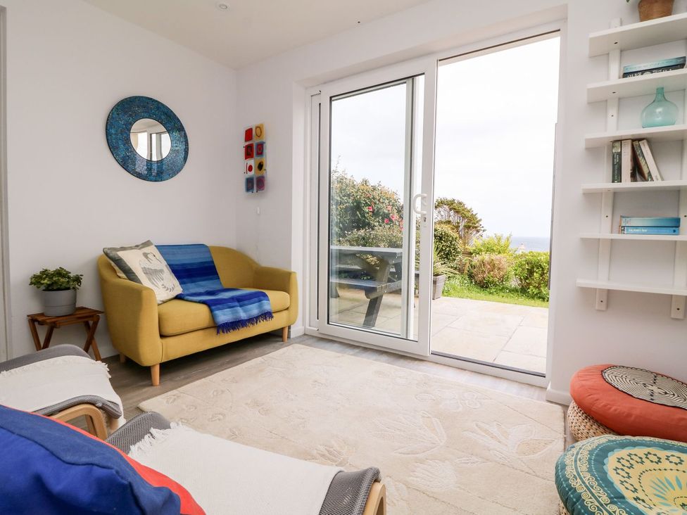 A living room with a sofa and sliding door at Wootton Gray Penzance