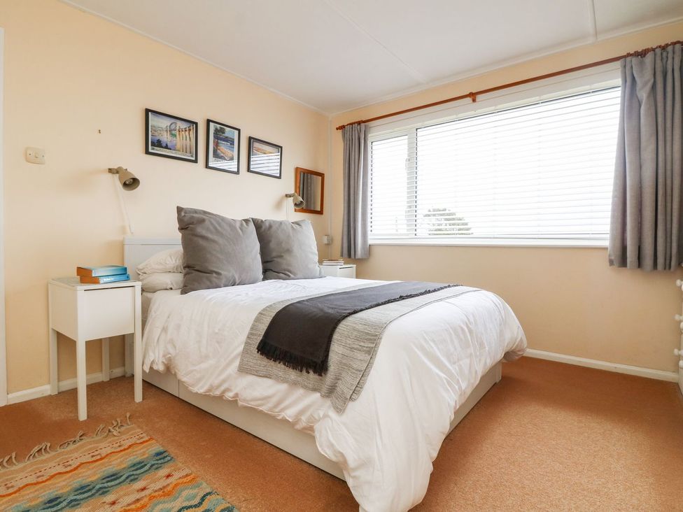 A bedroom with a bed and bedside table at Wootton Gray in Penzance