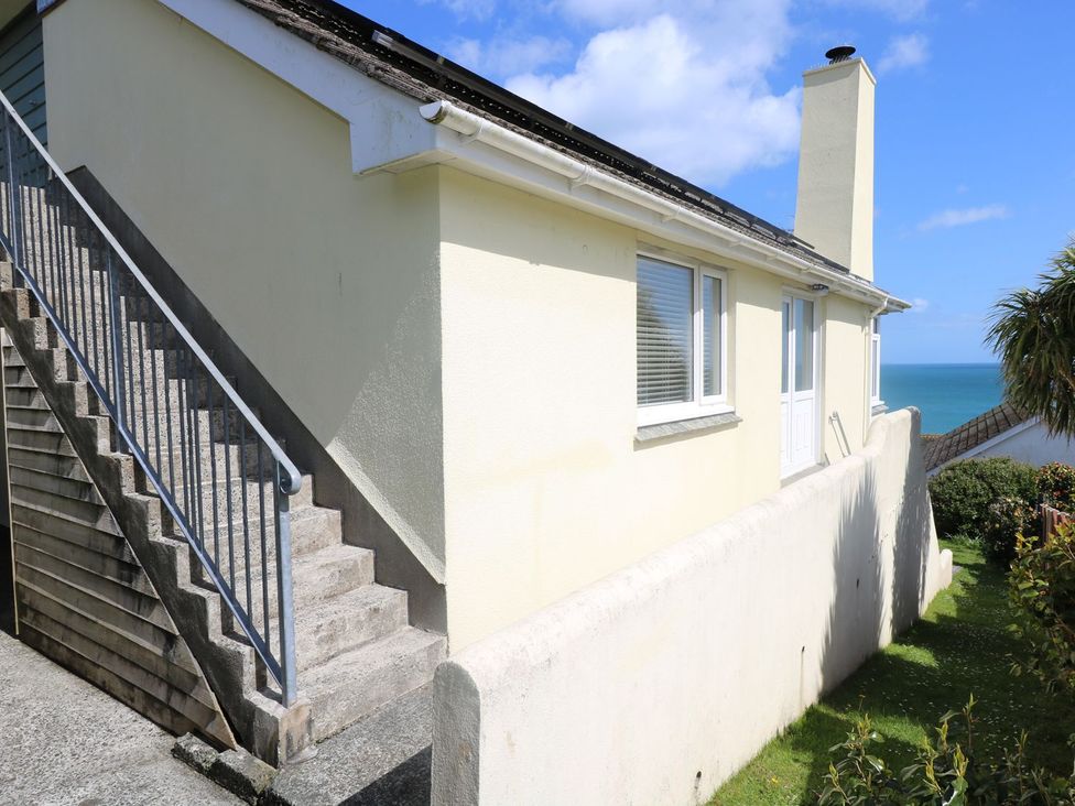 A building exterior with stairs leading to a door at Wootton Gray in Penzance