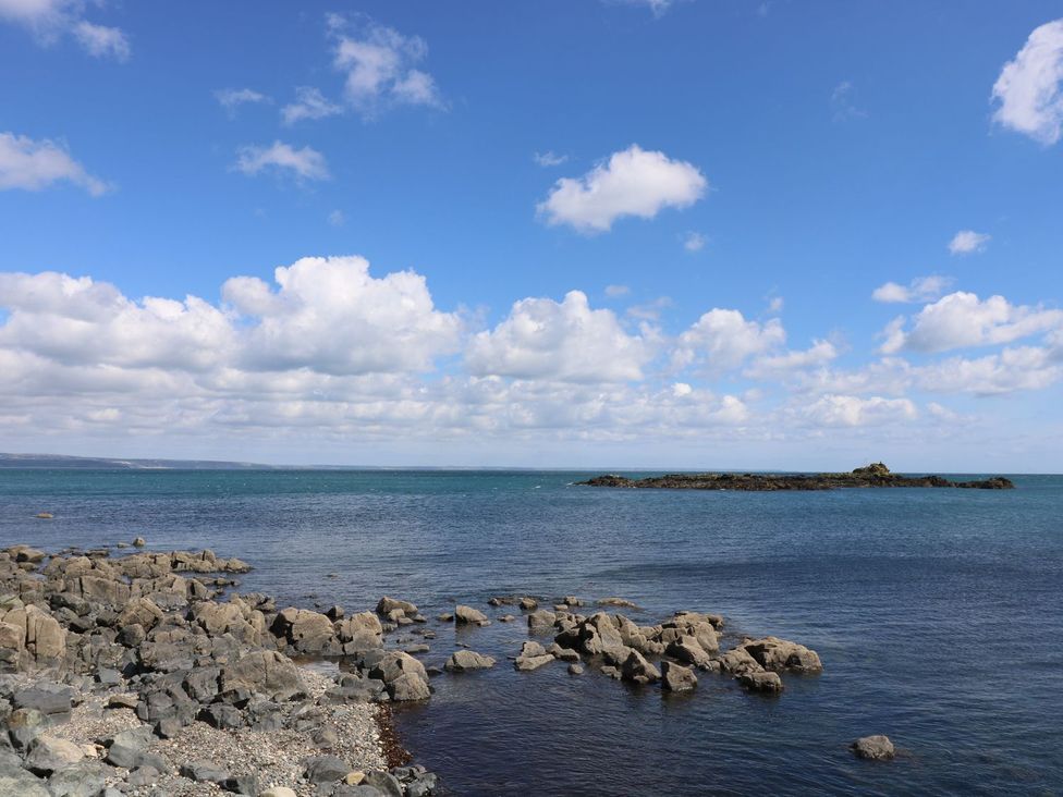 A coastal scene with water rocks and island at Wootton Gray in Penzance