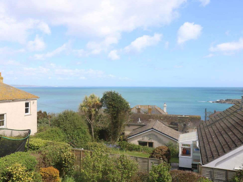 A view of the sea and houses in the foreground at Wootton Gray in Penzance